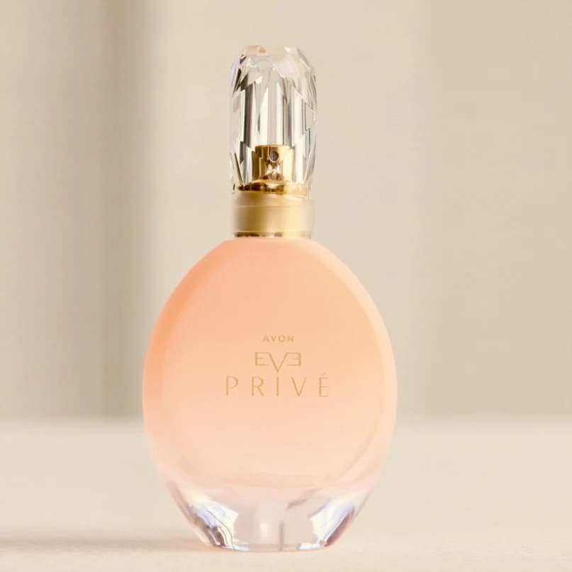 avon eve prive [perfume bottle on a cream background